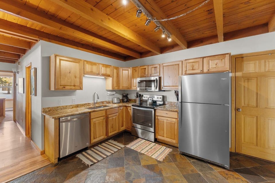 Updated full size kitchen with granite countertops and stainless steel appliances.