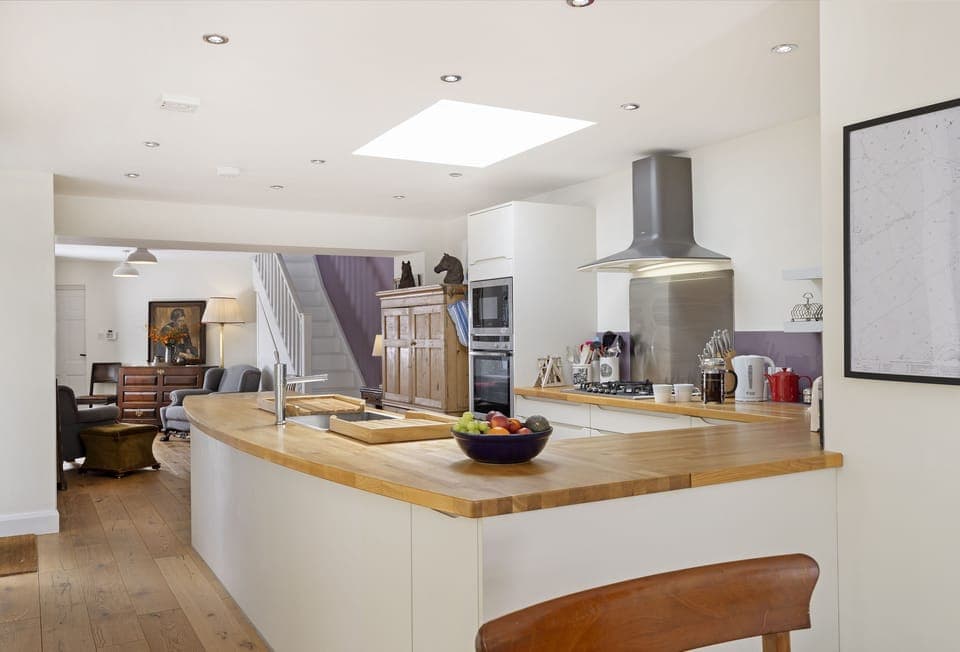 Ground floor: Open-plan living space with well-equipped kitchen leading to seating area