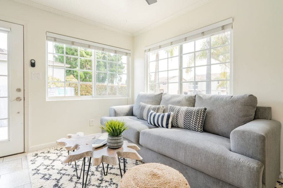 Living room with sofa bed, ceiling fans, TV with cable, dining table for 4, washer and dryer and one Mini split AC unit in the living room (one unit for the whole cottage).