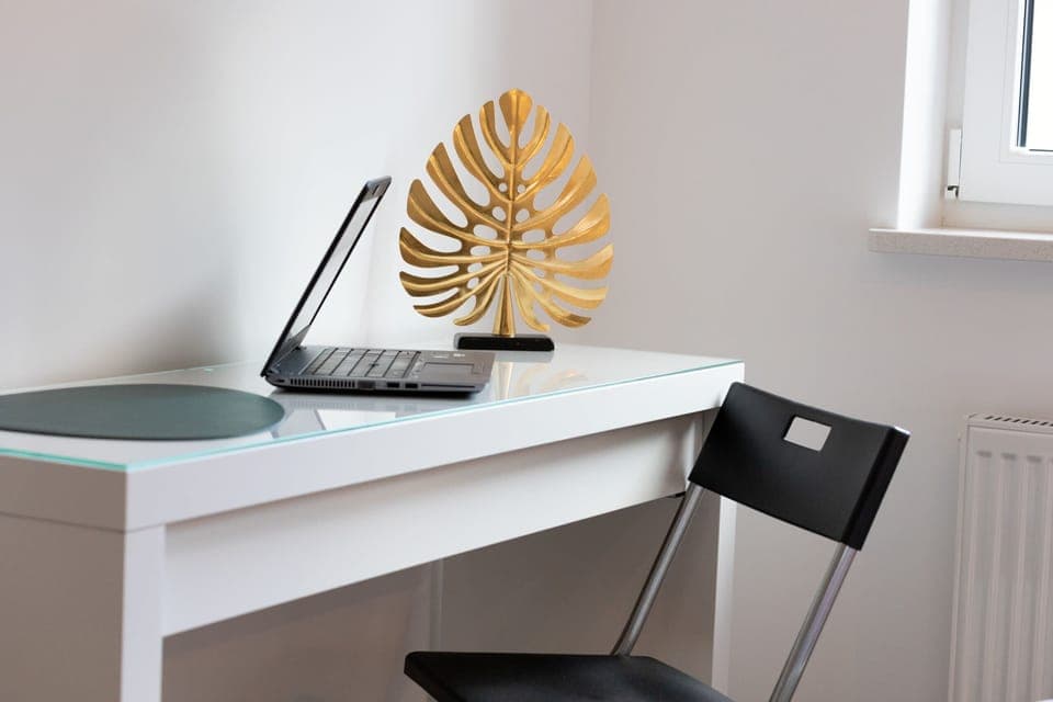 A neatly arranged desk in a minimalist design, perfect for remote work or study.
