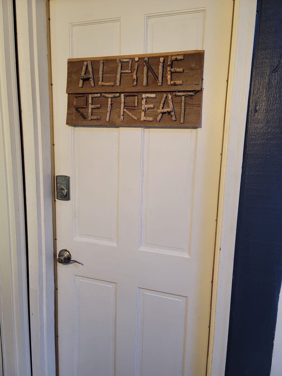 Private access door in shared entrance foyer to the Alpine Retreat unit.