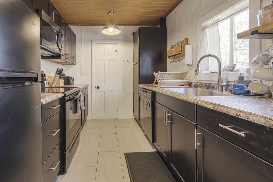 Full kitchen with stove, oven, refrigerator, and coffee maker