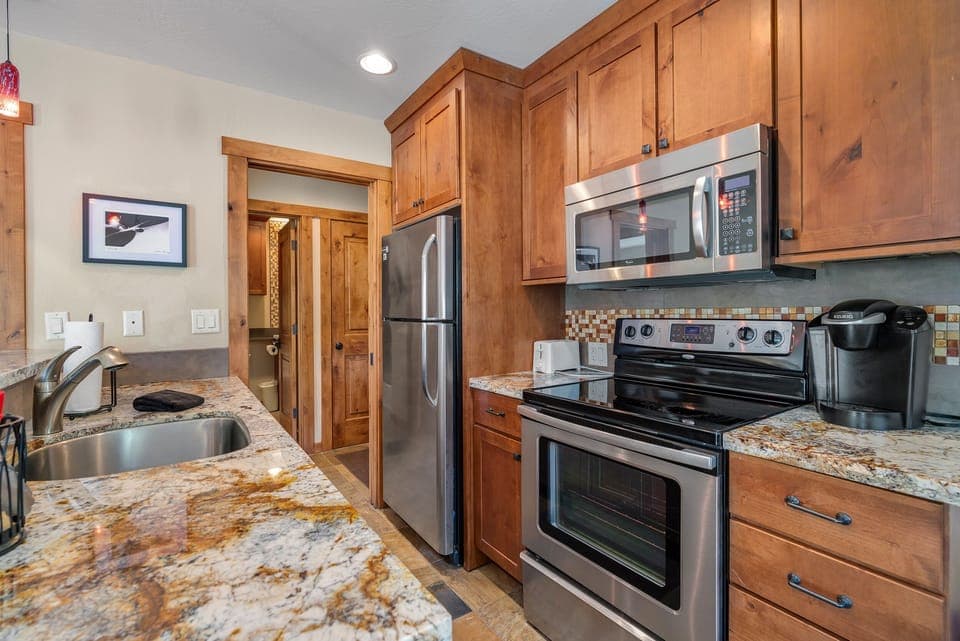 Remodeled kitchen with stainless steel appliances and granite counter tops