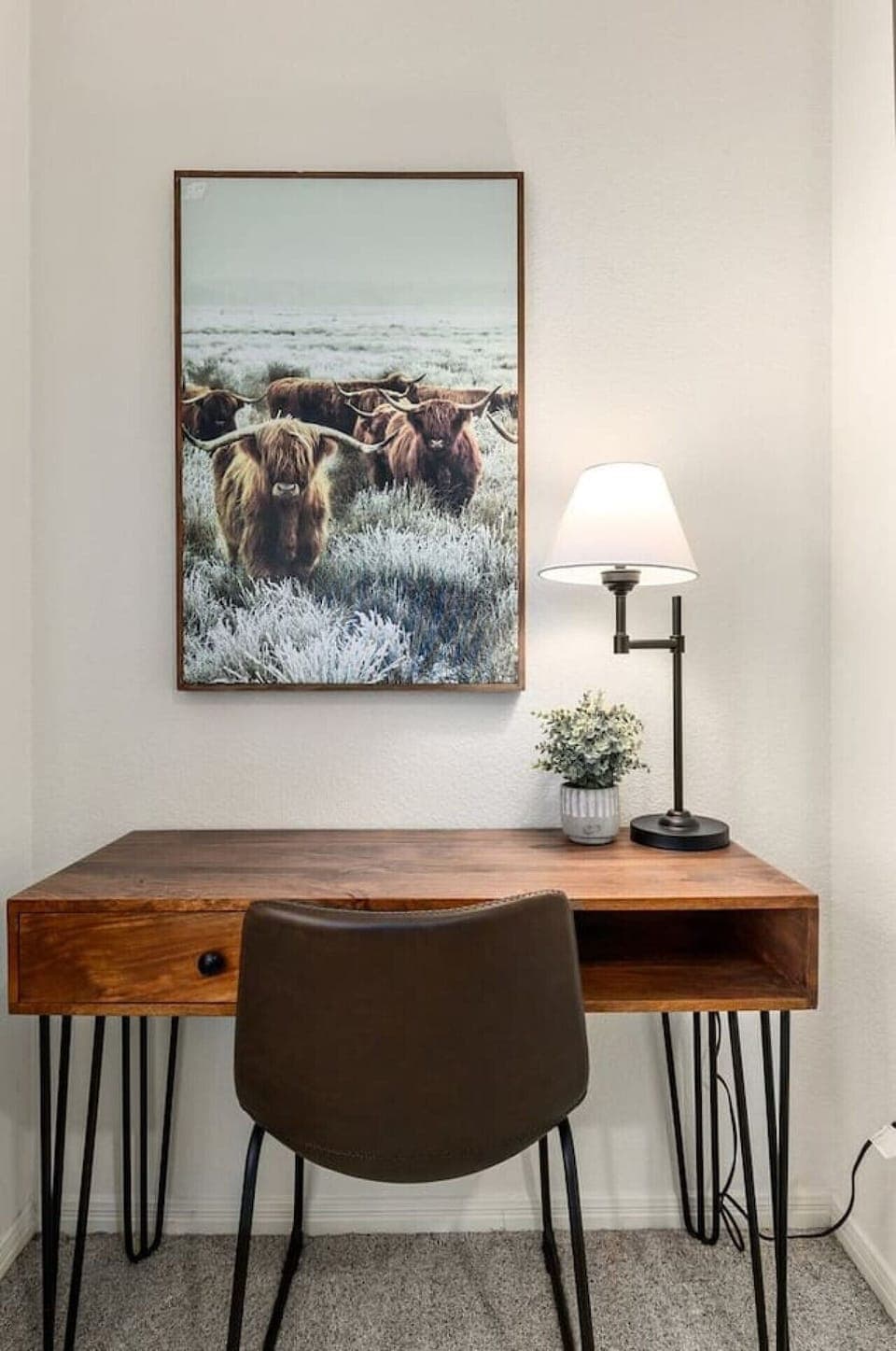 Dedicated work nook with warm lighting and Texas-inspired art—ideal for remote work or creative projects at Machete Place.