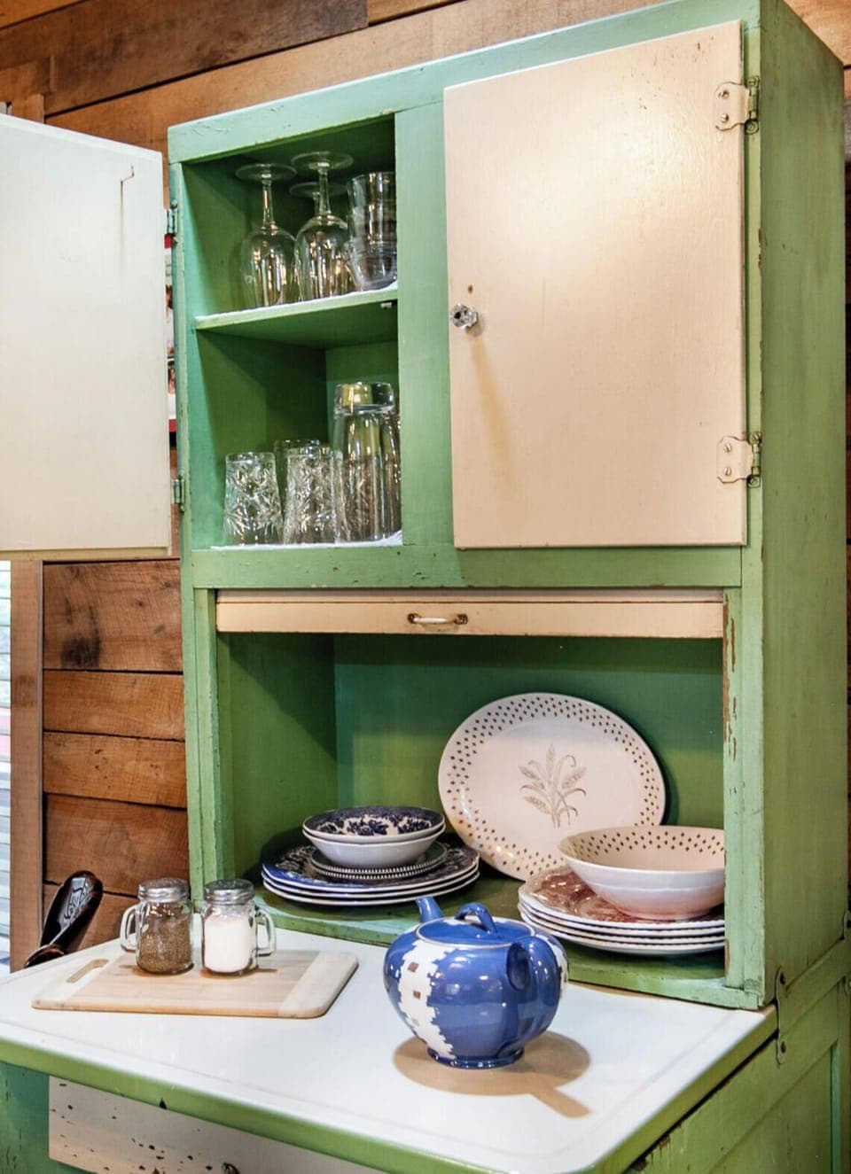 Featuring a pop of color with a bright red countertop and a charming green cabinet, this kitchen is the perfect blend of style and functionality. Ideal for creating memories with loved ones.