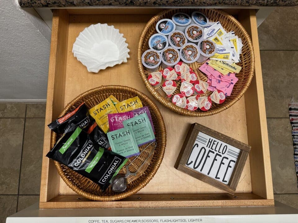 Fuel up fast before the pool—stocked coffee drawer with K-cups, grounds, tea, and sweeteners at Lakeside Haven, The Island on Lake Travis in Lago Vista.