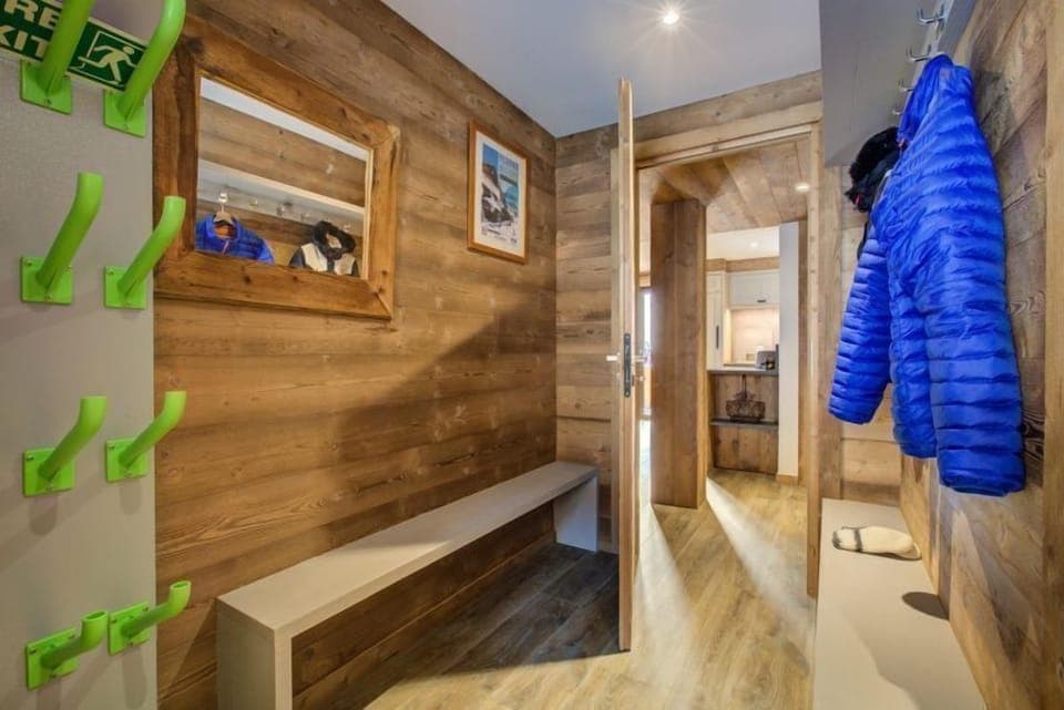 The spacious corridor features authentic wood touches and plenty of room to hang your ski stuff after a day outside.