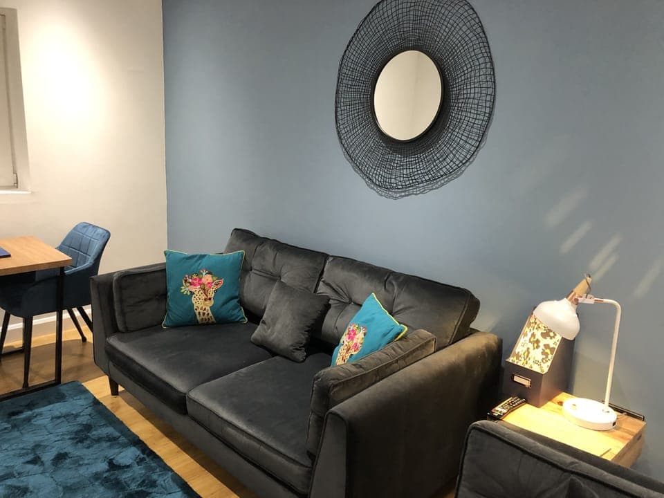 Lounge area with comfy Sofology sofa and love seat.