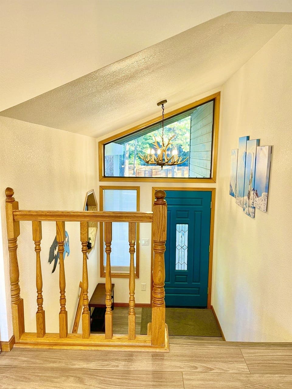 Deer chandelier hanging over stair landing