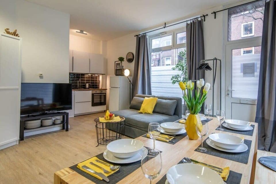 the living area is located between the dining area and the open kitchen