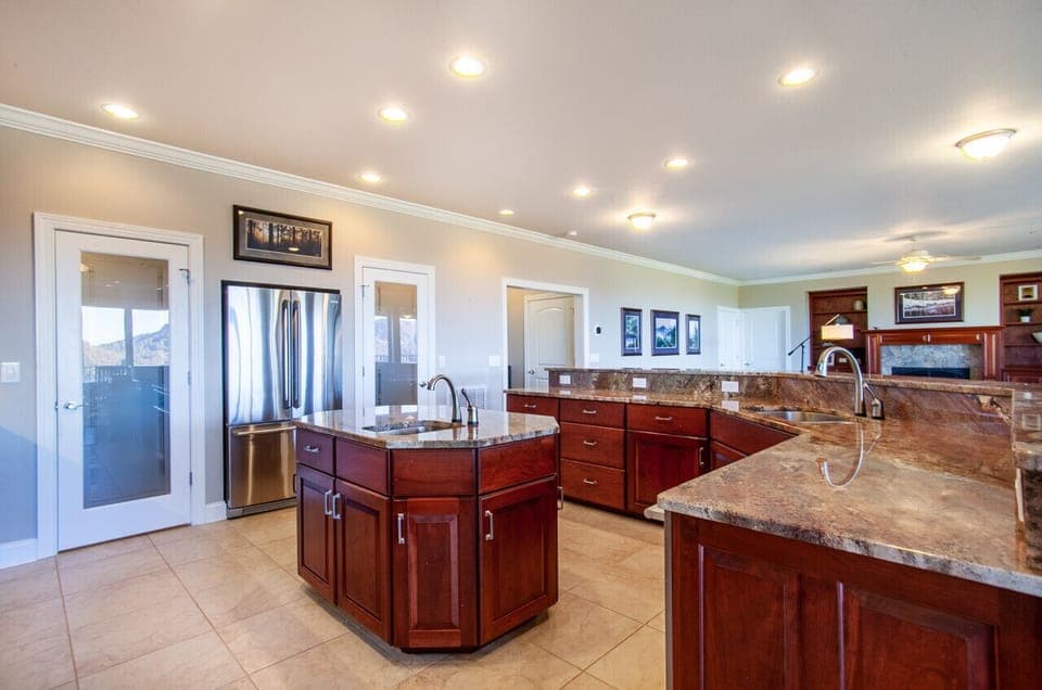 Rich wood cabinetry and stylish granite countertops blend perfectly in this sophisticated kitchen.