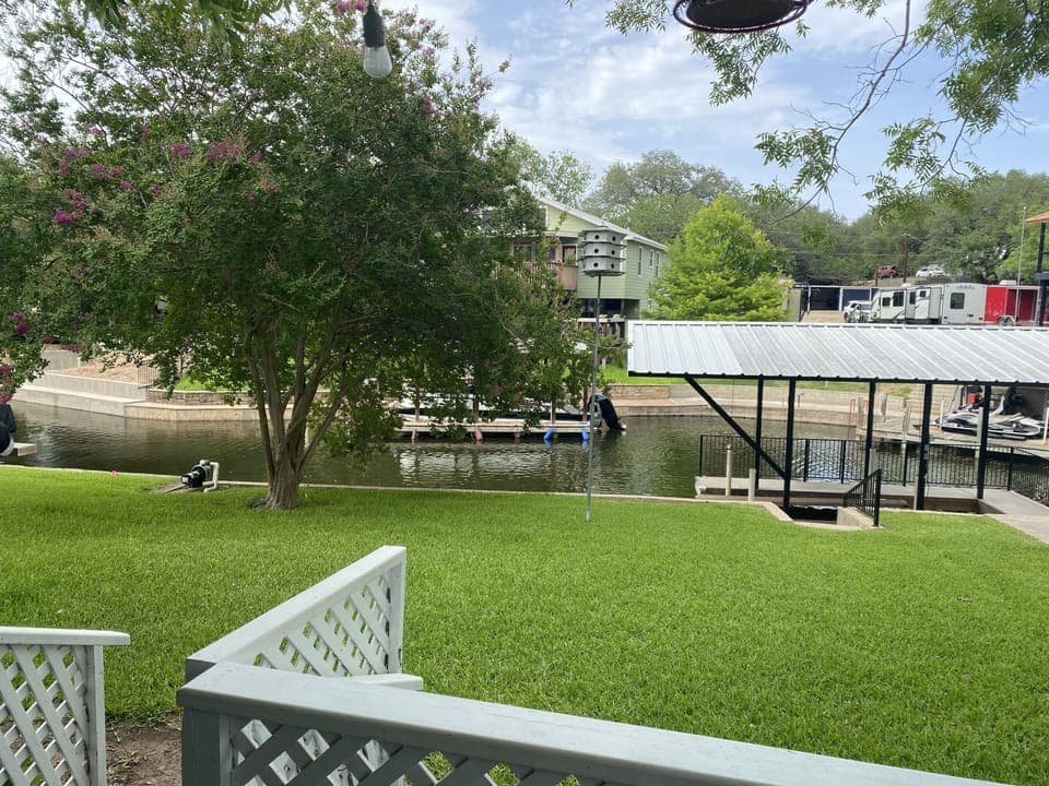 Backyard along channel.  Boat slips in use by owners.