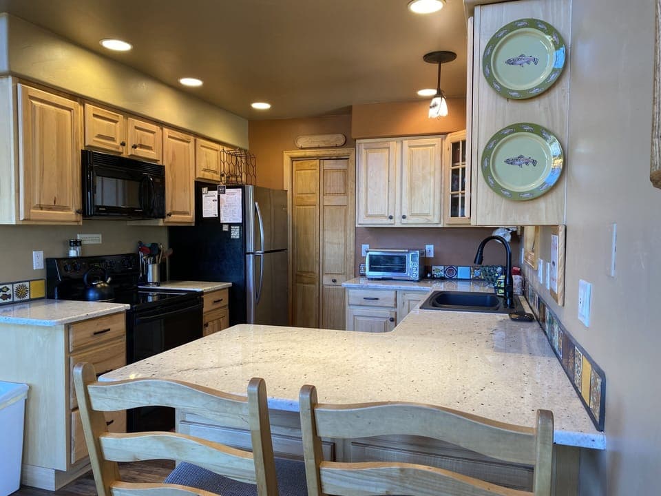 In the Kitchen, there is plentiful counter space and high-top seating for two at the bar.