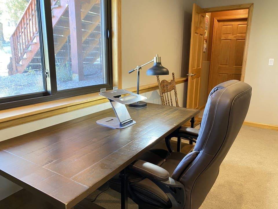 The Office space has a large desk facing a bright window, walkout access through the french doors...