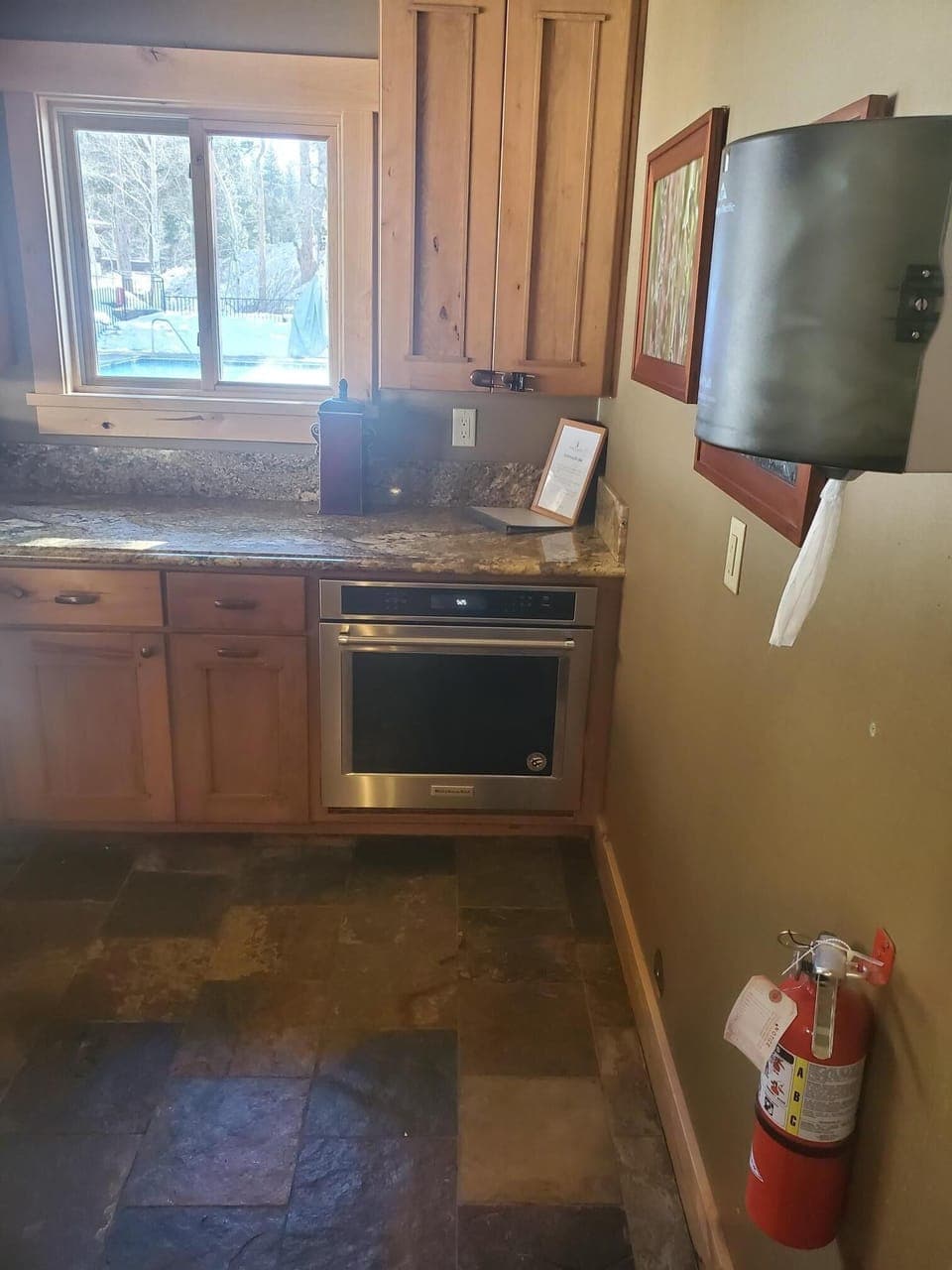 Shared kitchen and large seating area for guests to relax and enjoy fireplace.
