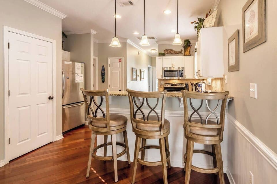 View of kitchen and back hallway from dining area