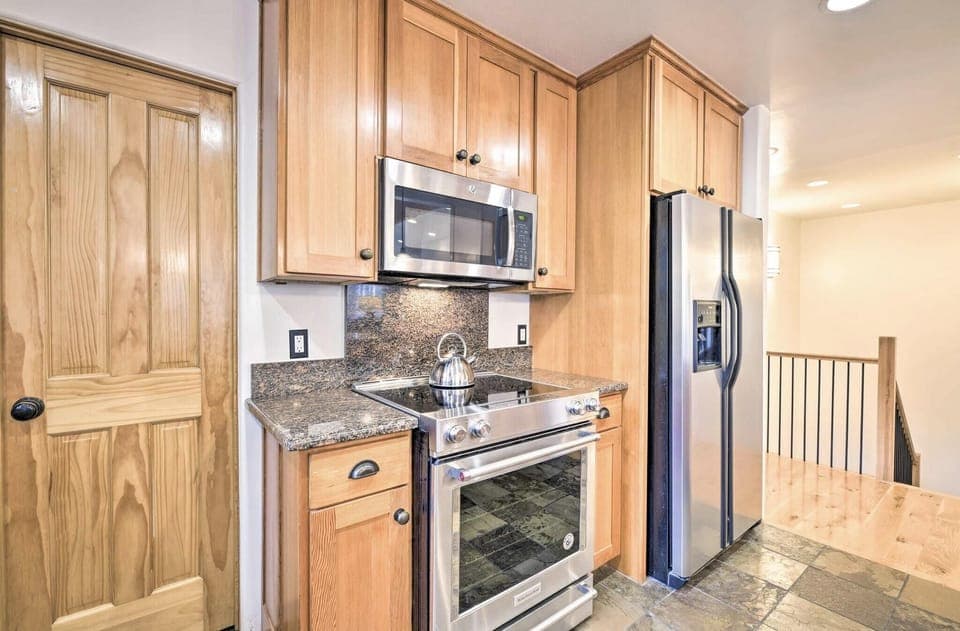 Kitchen fully stocked with dishware and cookware. Traditional drip coffee maker