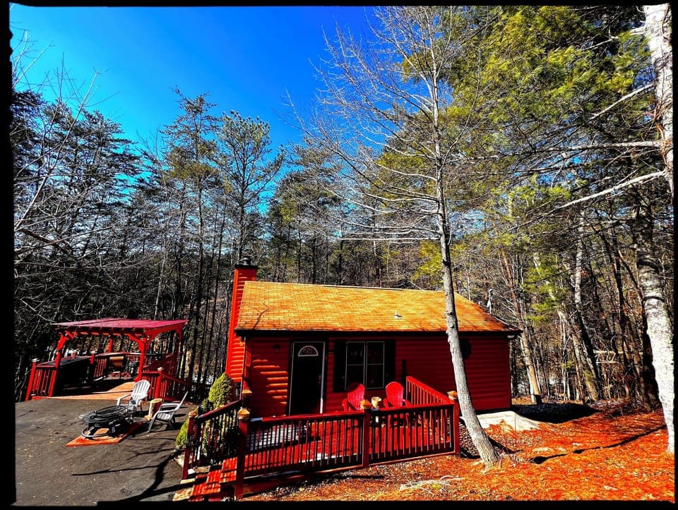 Front of cabin features patio with two chairs, Fire Pit & Pergola w/  Weber BBQ