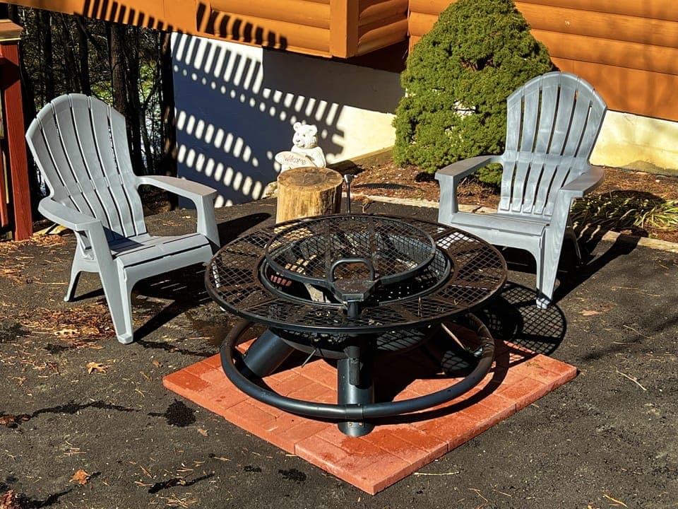 Fire pit area on driveway with two Adirondack chairs 