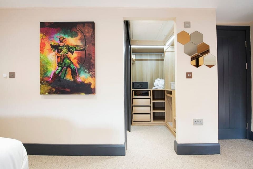 Master bedroom with walk in wardrobe and en suite. We have incorporated amazing local art into our homes - supporting local craftsmen and business and bringing our guests the best Village Holiday they could imagine. Apartment 1 mezzanine bedroom, guests m