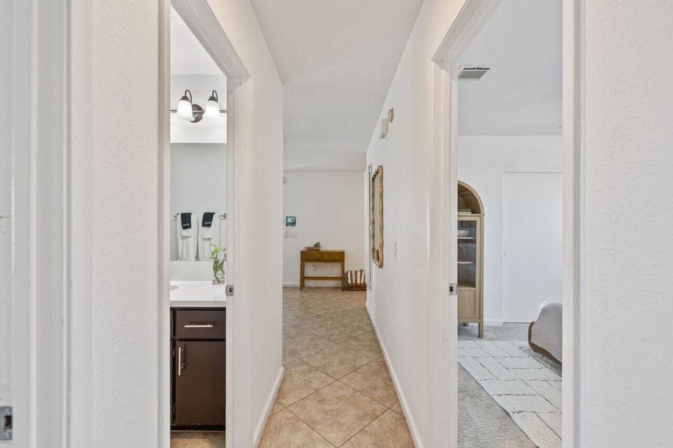 Bright hallway w/ easy flow connecting bedrooms & main living spaces