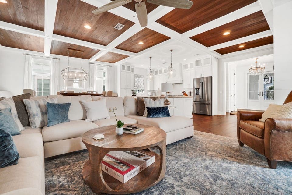 Relax in your elegant open-concept living space with stunning coffered wood ceilings and luxurious furnishings perfect for memorable gatherings.