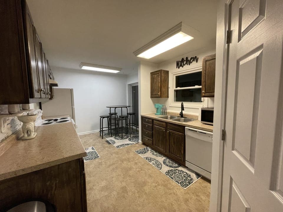 Kitchen provides access to the laundry room, patio and backyard