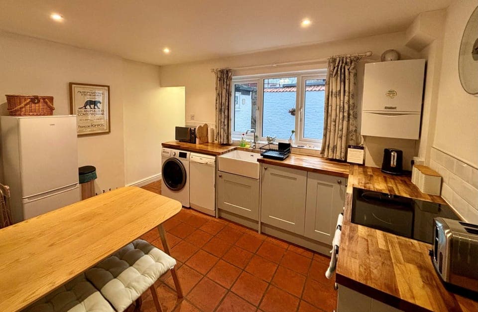 fully fitted kitchen with dining table
