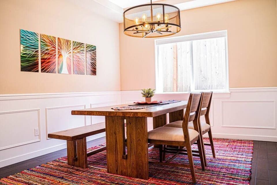 Bright and airy dining room with an open layout, perfect for intimate meals or entertaining, featuring large windows that bring the lush outdoors in.