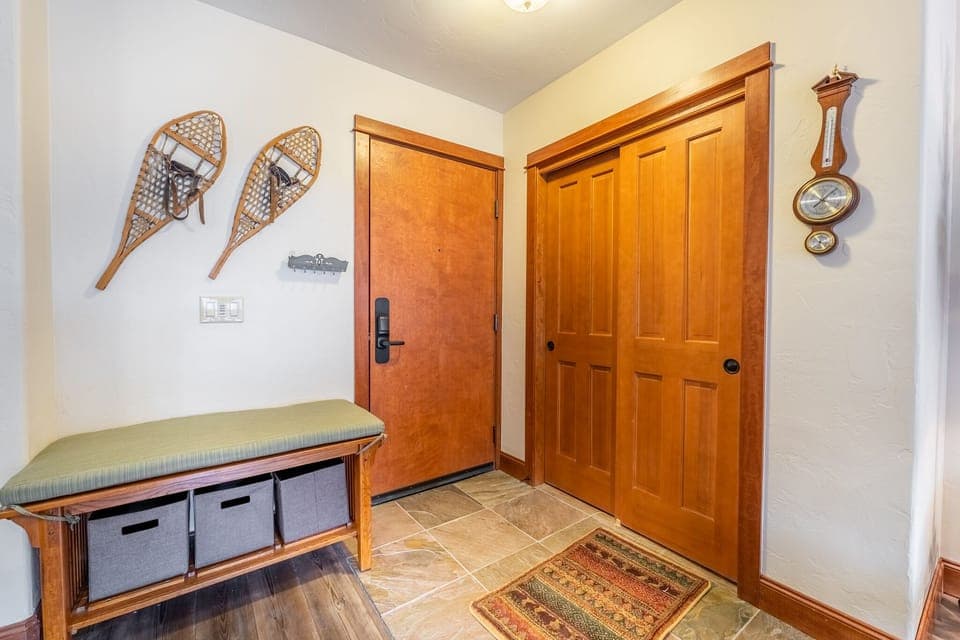 Entryway storage bench, closet and hooks for your convenience.
