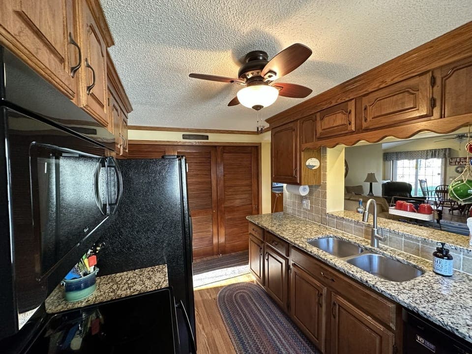 Kitchen with view to the back family room, dining table, patio and yard