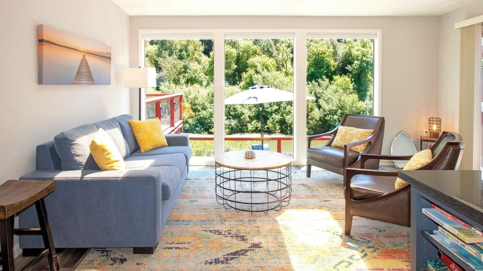 Riverfront sunroom with floor to ceiling windows. 