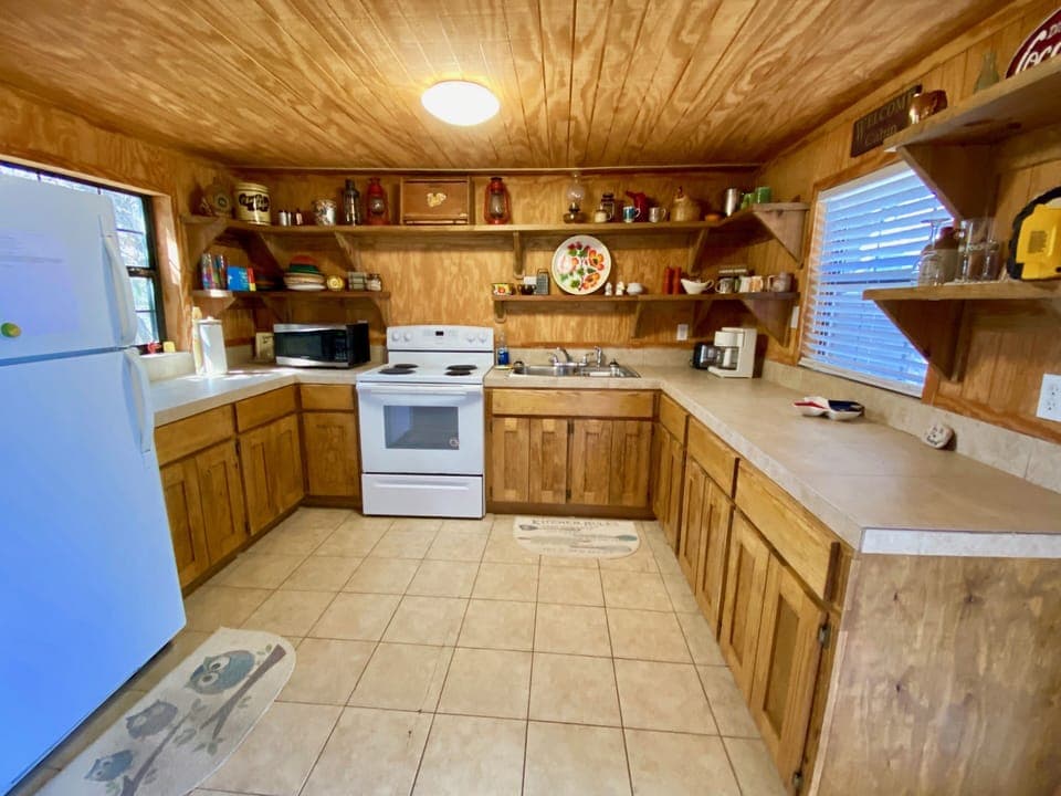 On the Rocks - A super rustic river shack kitchen decorated with antiques.