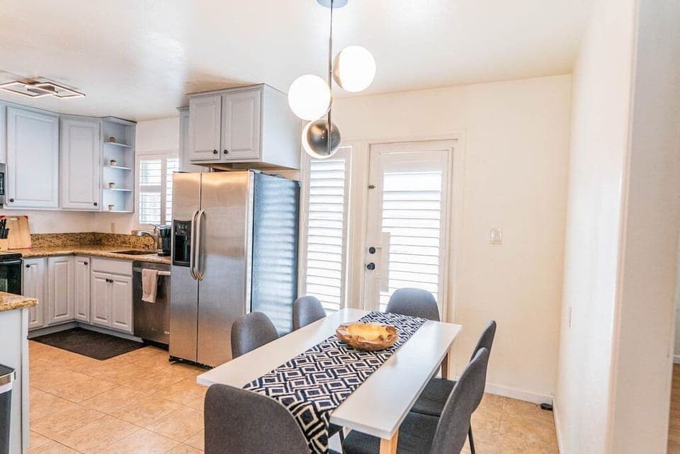 Dining table for 6 guests with comfy clothe chairs.