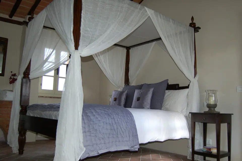 Teak four-poster bed in principal bedroom.