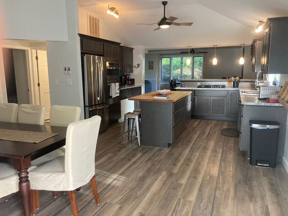 View of eat-in kitchen with full dining set, kitchen island, and updated kitchen