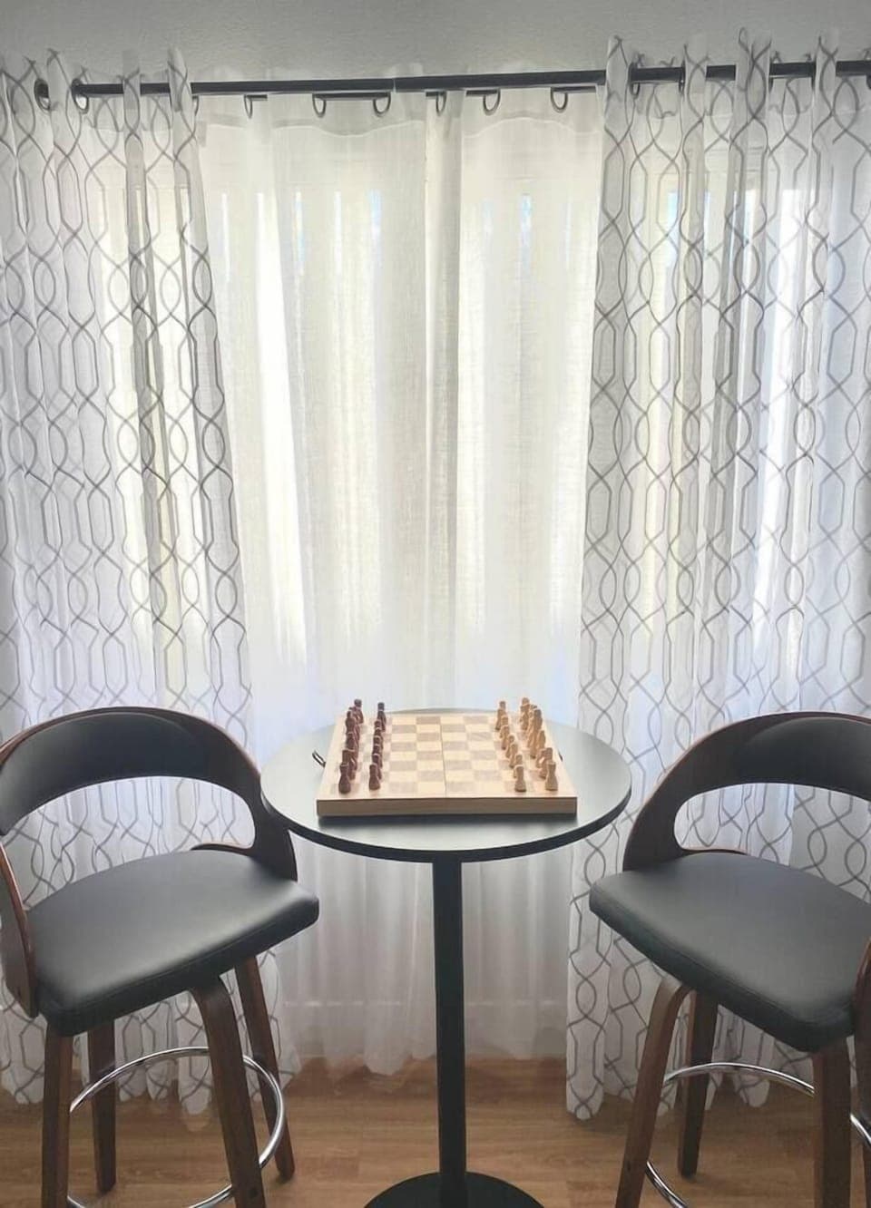 Comfortable bar stools and table for enjoying a drink or a game.