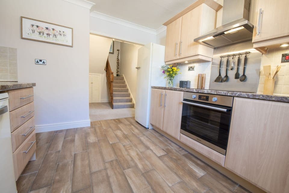 Ground floor: Fully-equipped kitchen leading to stairs to first floor