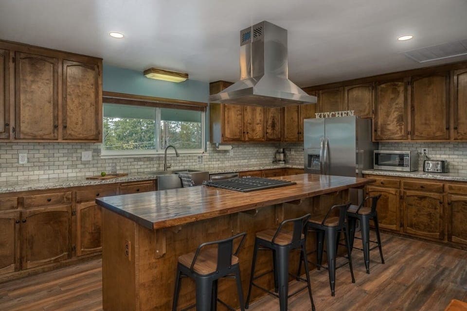 Large open kitchen well stocked with cooking essentials.