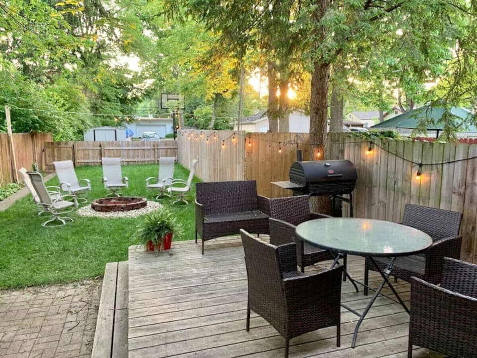 Backyard with plenty of seating, charcoal grill, fire pit and outdoor lighting!