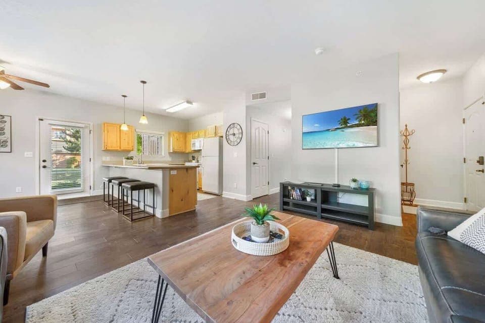 Big flat screen tv an open concept space that flows into the kitchen 