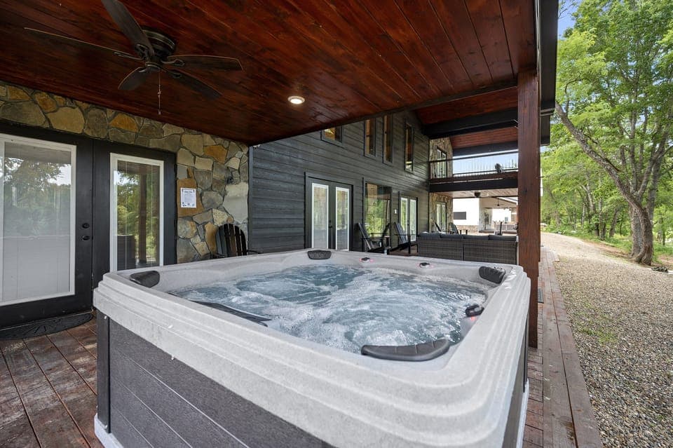 Unwind in the private hot tub under a covered patio with soothing sounds of the river nearby.