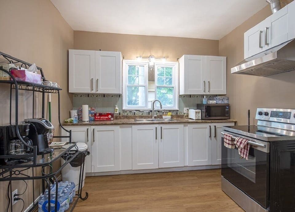 Fully appointed kitchen with fridge, stove, coffee maker, Kurig, & microwave.