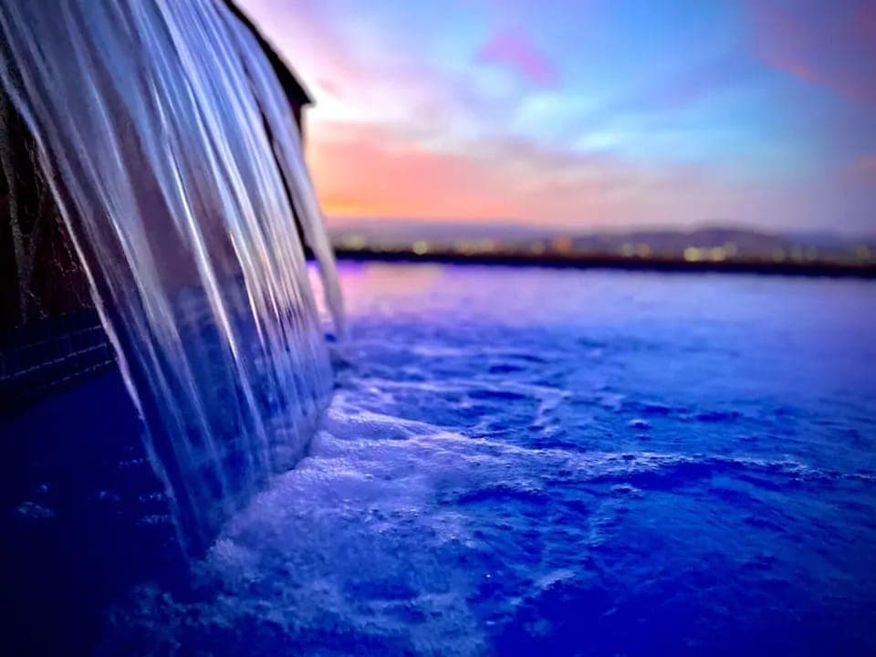 Drizzling, aquarium blue pool & spa. Heated for all year round use capability.