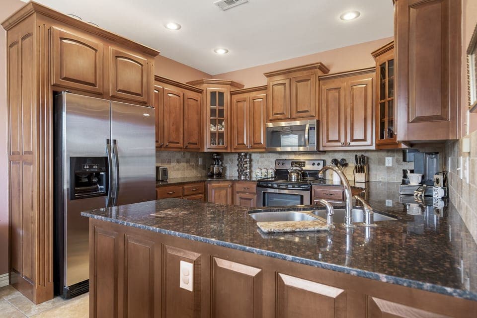 This kitchen is fully stock with pots/pans, cooking utensils, and coffee bar.