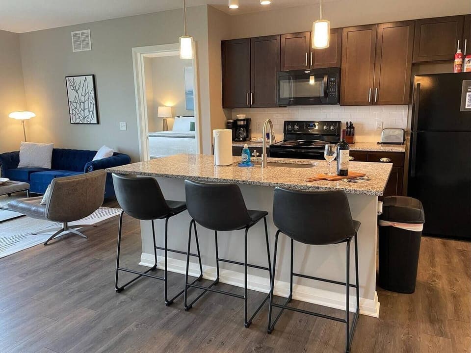 Beautiful kitchen island with granite countertops and comfortable bar stools!