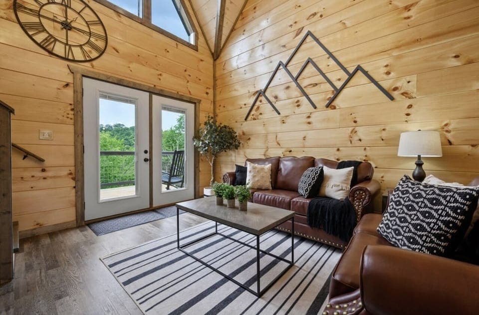 Main living room with high vaulted ceilings.  Has walk out to upper patio deck.