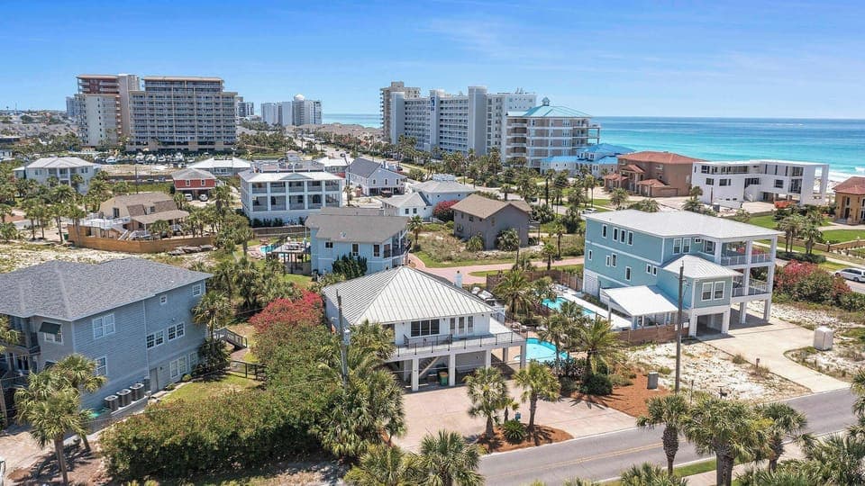 Elevated neighborhood view w/ rooftops, streets, & a coastal vibe