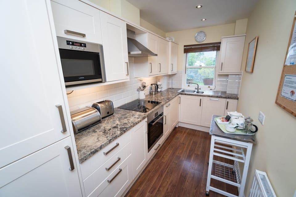 A beautifully maintained kitchen at the rear of the property