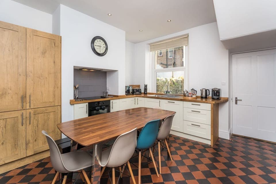 The ground floor kitchen is spacious and has a large dining table for everyone to enjoy meals together